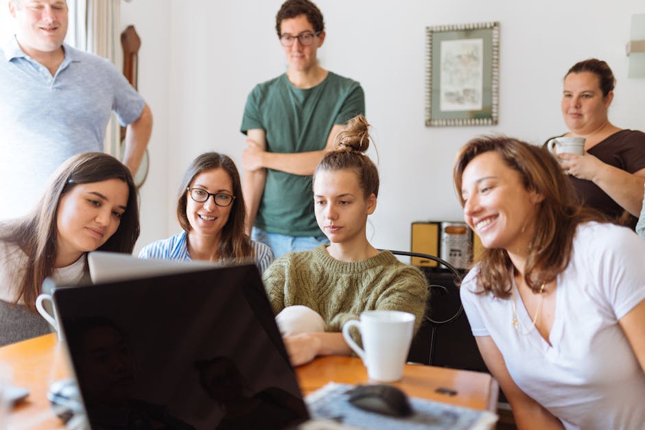 A diverse group of adults at work, enjoying a casual meeting indoors